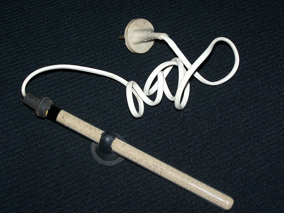 A glass aquarium heater with its unplugged power cord